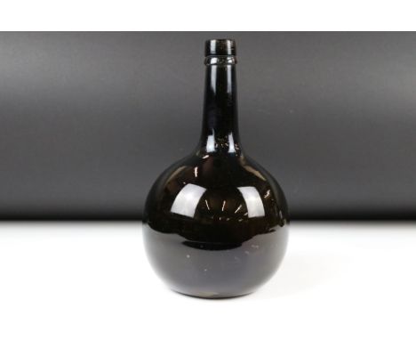 18th century English Glass Bottle of Onion form with light brown hue, string rim and shallow kick up, 25cm high 