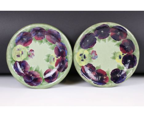 Pair of William Moorcroft Shallow Bowl or Plates decorated in the pansy pattern on green ground, impressed marks to base and 