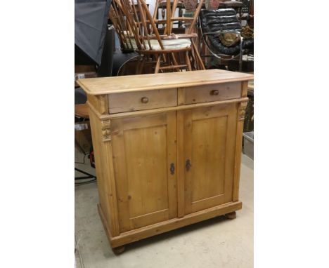 Victorian Pine Dresser Base or Side Cabinet with two drawers over two cupboard doors opening to a shelf, raised on bun feet, 