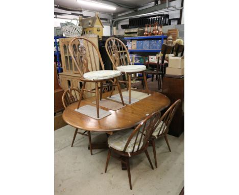 Set of Six Ercol Elm and Beach Dining Chairs with Fleur de Lys Hoop Backs and seat pads together with an Ercol extending Oval