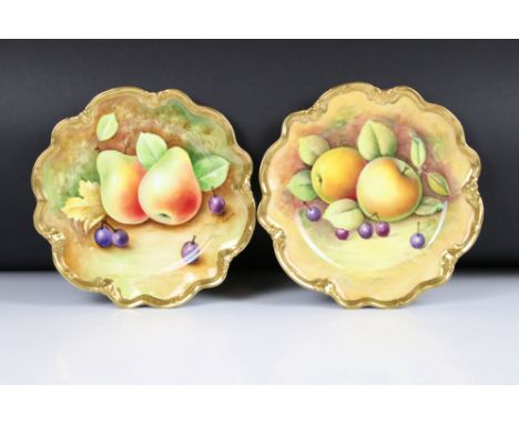 Pair of Coalport Cabinet Plates, hand painted with fallen fruits within a gilt wavy rim, one decorated by Norman Lear and the