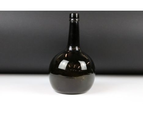 18th century English Glass Bottle of Onion form with light brown hue, string rim and shallow kick up, 25cm high 