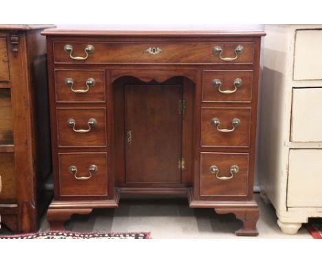George III style Mahogany Kneehole Desk with an arrangement of seven drawers and central cupboard to kneehole recess, raised 
