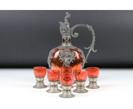 Continental Art Nouveau Pewter and Red Glass Liqueur Set comprising a Decanter and Stopper 22cm high and Six Liqueur Glasses 