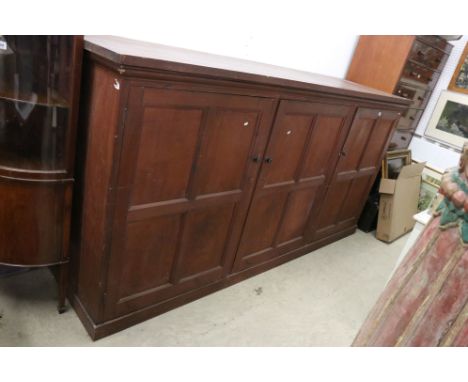 Late 19th / Early 20th century Large Stained Pine Cupboard, the three panel doors opening to shelves (one door currently lock