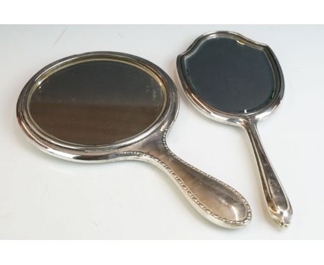 Two fully hallmarked sterling silver hand mirrors, both with engine turned decoration. 