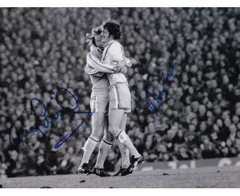 Football Autographed LEEDS UNITED 8 x 6 Photo : B/W, depicting Leeds United's TONY CURRIE celebrating with teammate ALLAN CLA