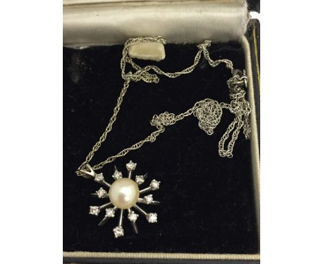A 14k chain and diamond and pearl pendant