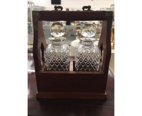 A mahogany two decanter tantalus