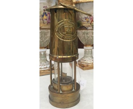 A brass miner's lamp by E Thomas & Williams