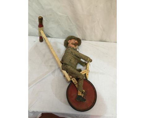 A child's toy of an automaton unicyclist, c1950s