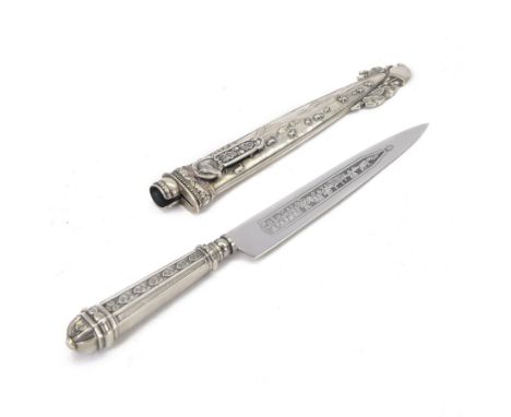 Argentinian Gaucho dagger and scabbard, decorated with oak leaves and cattle scenes with Inox blade, overall L29cm, blade 17c