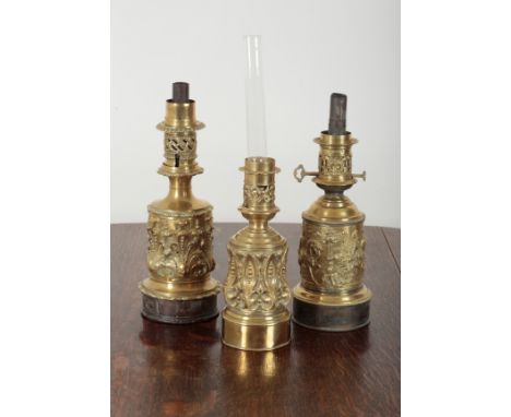 A 19TH CENTURY FRENCH EMBOSSED BRASS TABLE OIL LAMP BY L. HADROT the body decorated with cavaliers, 40cm high, together with 