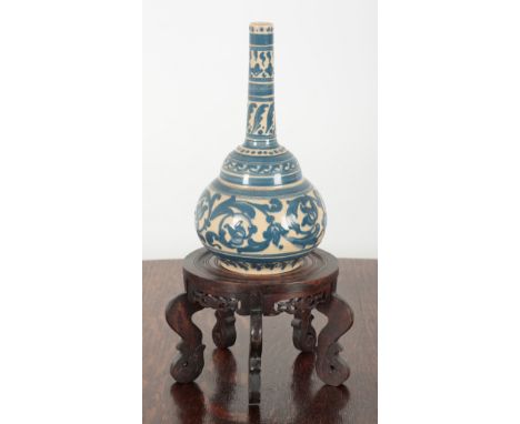 A LATE 19TH CENTURY BLUE AND WHITE POTTERY BOTTLE SHAPED VASE decorated with scrolled leaves, 33cm high, together with an ass