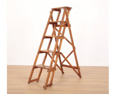 AN EARLY 20TH CENTURY POST OFFICE BEECHWOOD FOLDING LADDER the six graduated treads with crudely applied brass strips, presum