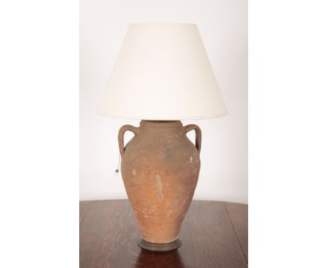 AN EARTHENWARE AMPHORA LAMP 20th Century, with metal mounts to neck and base, 50cm high, with shadeProvenance: The residual c