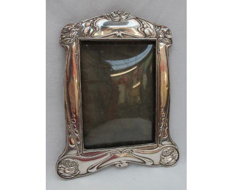 An Art Nouveau silver photograph frame, decorated with stylised flowerheads and leaves, Birmingham, 1904, Synyer &amp; Beddoe