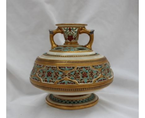 A Royal Worcester reticulated Persian style twin handled vase, in two sections, decorated with flowerheads and leaves on a sp