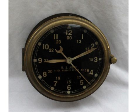 A U.S. Army Clock, Message Centre, M2 bulk head time piece with a black dial, luminous hands and seconds sweep with Arabic nu