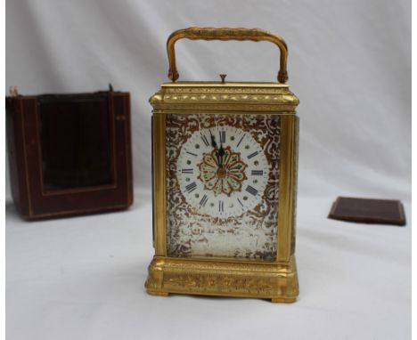 A 19th century French brass carriage clock, with a shaped folding handle and repeat mechanism with push button, striking on a