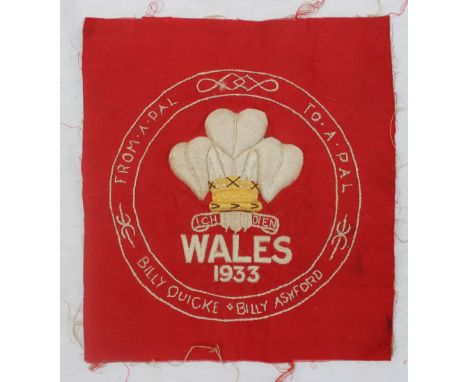 A tapestry panel embroidered with The Prince of Wales Feathers above "Wales 1933", the roundel embroidered "From a pal to a p