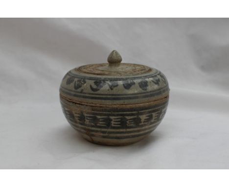 A Chinese pottery bowl and cover, decorated with grey and black stylised flowerheads to a grey ground, 10.5cm diameter