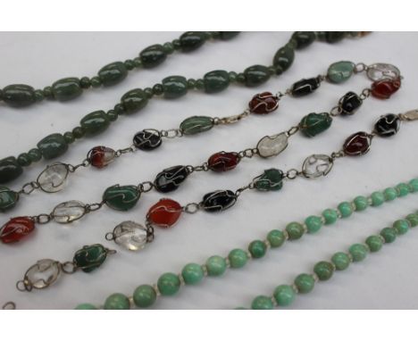 A jade bead necklace together with a hardstone graduated bead necklace, and a hardstone necklace and matching bracelet