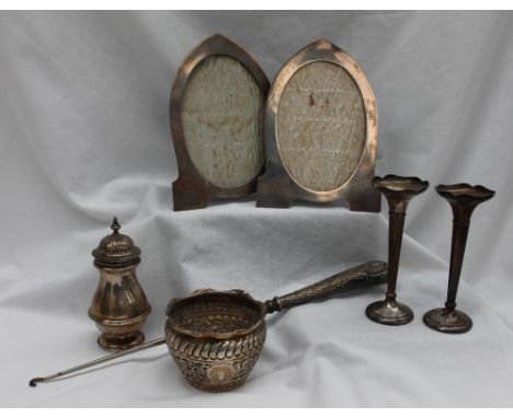 A pair of George V silver photograph frames of pointed oval form, Birmingham, 1922, together with a silver sugar sifter, silv