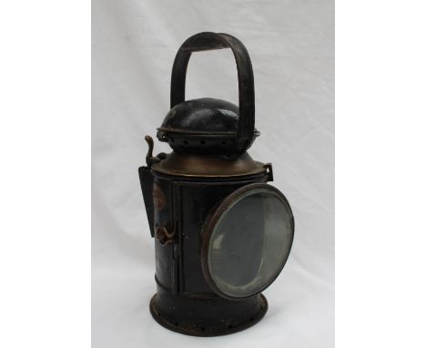 A GWR signal box lamp with an arced handle, with a hinged glazed door, burner and reflector, No.21574, 31cm high used by C St