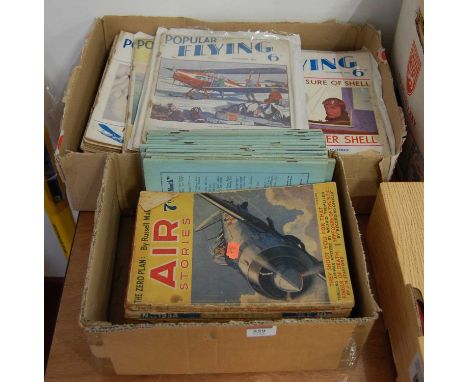Two boxes containing a quantity of mixed military ephemera and books, to include 1930s Popular Flying magazine, The Patrician