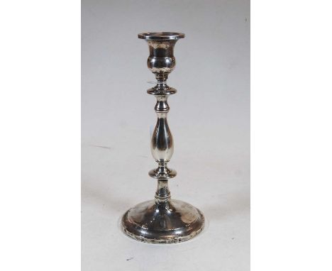 An early 20th century sterling silver table candlestick, of typical knopped form to a circular foot rim, on weighted base, h.