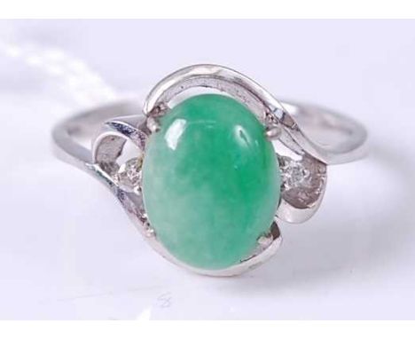 A 14ct white gold cabochon jade and twin diamond highlight set dress ring, 4g, size L/M