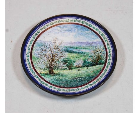 A Persian white metal and enamel shallow bowl the centre enamel decorated with a mountain river landscape with further floral