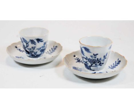 A pair of 19th century tea bowls and saucers, each underglaze blue decorated with birds and flowers