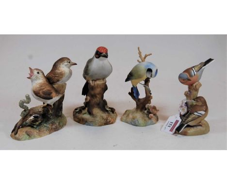 A collection of three Royal Crown Derby bird figures, comprising Thrush chicks, Blue-tit, and Woodpecker; together with a Wor