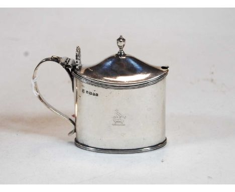 A Victorian silver mustard, of oval form, having blue glass liner, the cover with acorn finial and raised shell thumbpiece