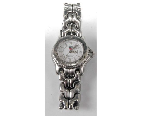 A lady's Tag Heuer steel quartz wristwatch, having white enamel dial signed Professional 200m, and with luminous baton marker