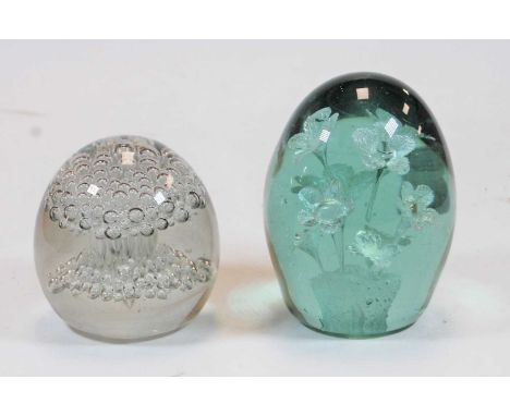A Victorian green tinted glass 'end of day' weight, the interior decorated with flowers; together with a clear glass desk wei
