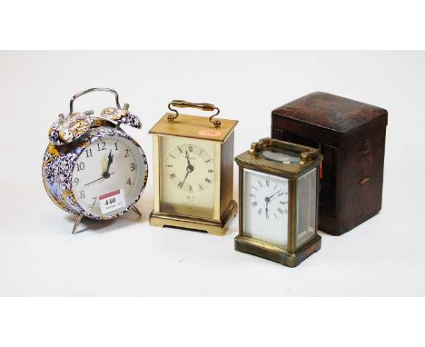 An early 20th century lacquered brass cased carriage timepiece having an enamel dial with Roman numerals, visible platform le