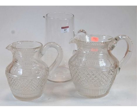 A 19th century hobnail cut glass jug, height 19cm, together with one other matching smaller example and a glass pitcher (3)