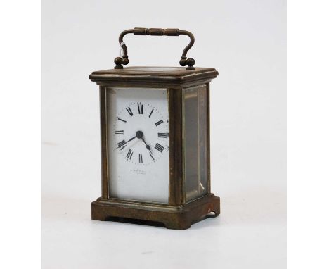 An early 20th century lacquered brass cased carriage timepiece having an enamel dial with Roman numerals, signed indistinctly