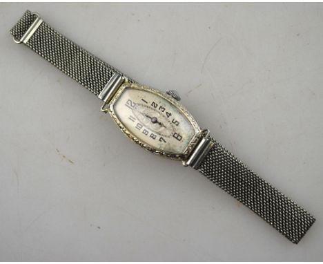 A 1920's lady's 18kt Art Deco cocktail watch with 17-jewel 'Fidea' movement and engraved and silvered tonneau dial, on base-m