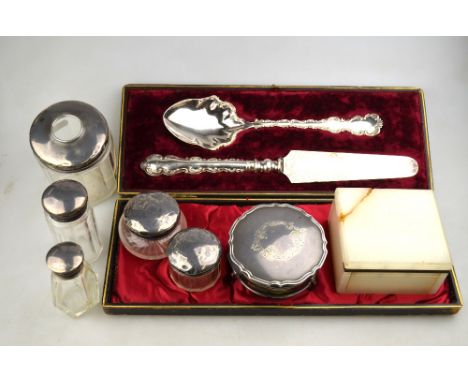 A circular silver trinket box with hinged cover, Birmingham 1917, to/w three silver-topped toilet jars, an Asprey's onyx ciga