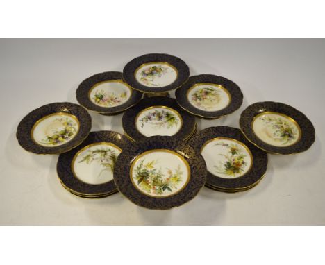 A Victorian Royal Worcester dessert service, the centres painted with floral sprays within a dark blue and gilded border comp