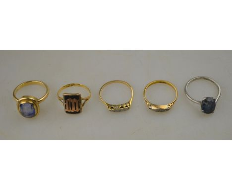A collection of five stone set rings, one set with rectangular Ceylon sapphire, two set with small diamonds, one with platinu