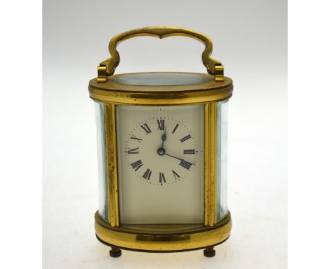 A lacquered brass ovoid cased carriage clock with folding carrying handle, 15 cm high overall Condition Report Outwardly good