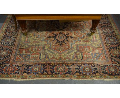 An antique Persian Heriz carpet with traditional geometric design on camel/pale blue ground, 217 x 320 cm