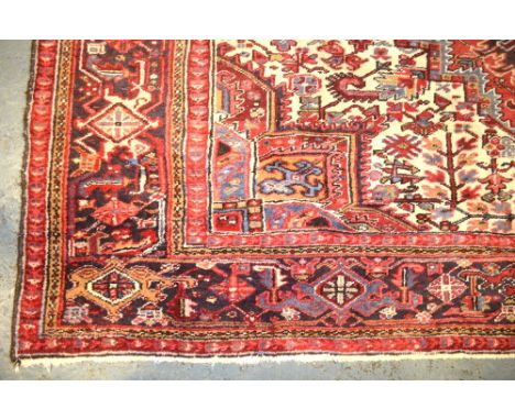 A Persian Heriz carpet, traditional geometric triple medallion design, 388 x 278 cm