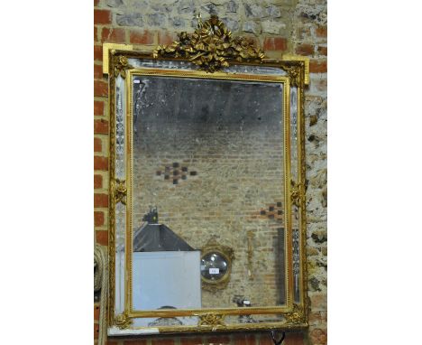 A 19th century giltwood and plaster framed overmantel mirror, the ribbon bow surmount over etched mirror border panels, 128 c