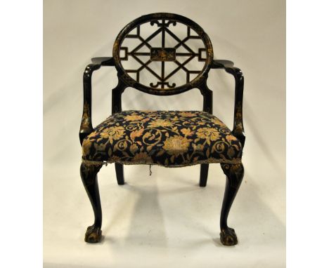 A black lacquered and polychrome decorated Chinese Chippendale style elbow chair with Morris style overstuffed seat